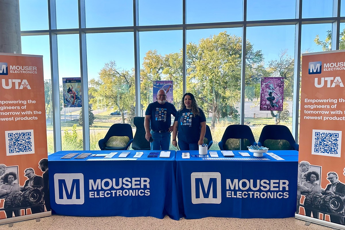 Two people standing behind a Mouser and UTA booth, smiling and facing twoards the camera - opens in a new tab